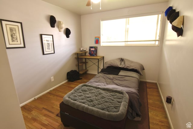 3223 S Fairlane St, Magna, UT 84044 - bedroom with baseboards, ceiling fan, and wood finished floors