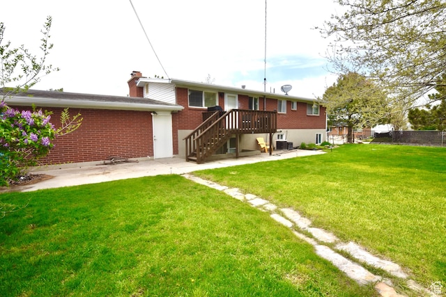 3223 S Fairlane St, Magna, UT 84044 - back of property featuring a lawn, central AC unit, a patio area, brick siding, and fence
