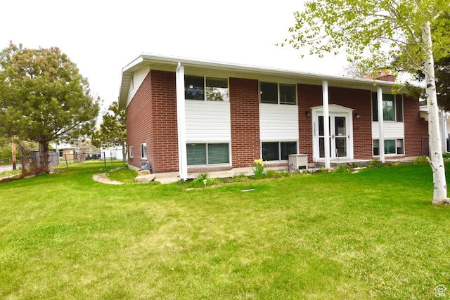 3223 S Fairlane St, Magna, UT 84044 - back of property featuring fence, a yard, and brick siding