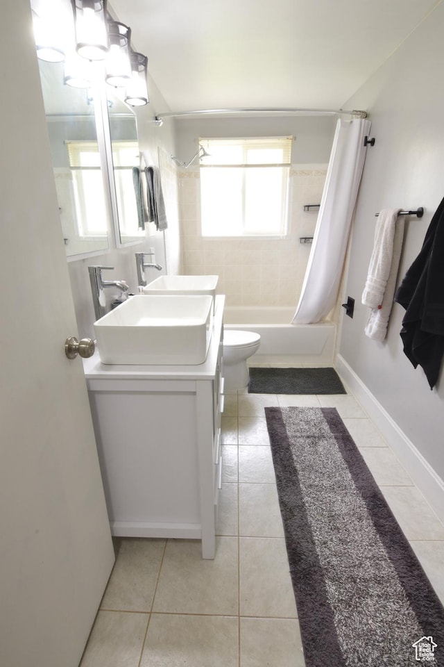 3223 S Fairlane St, Magna, UT 84044 - bathroom with vanity, shower / bath combo with shower curtain, toilet, tile patterned floors, and baseboards