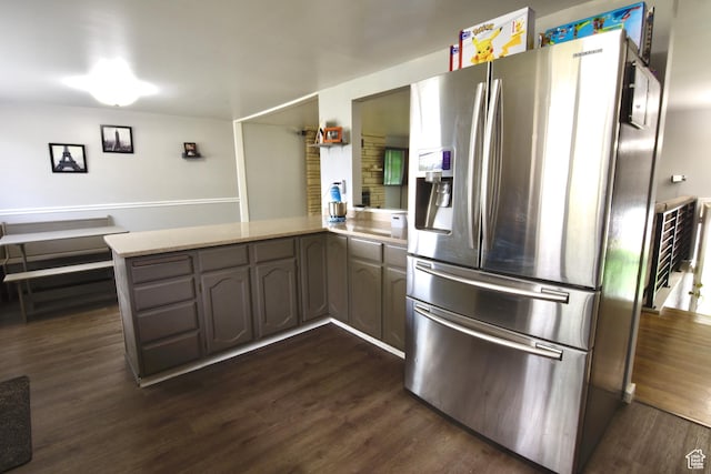 3223 S Fairlane St, Magna, UT 84044 - kitchen with dark wood-style flooring, light stone countertops, stainless steel fridge, and a peninsula