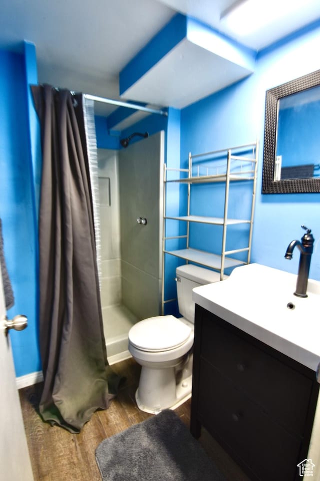 3223 S Fairlane St, Magna, UT 84044 - full bath with wood finished floors, a stall shower, toilet, and vanity