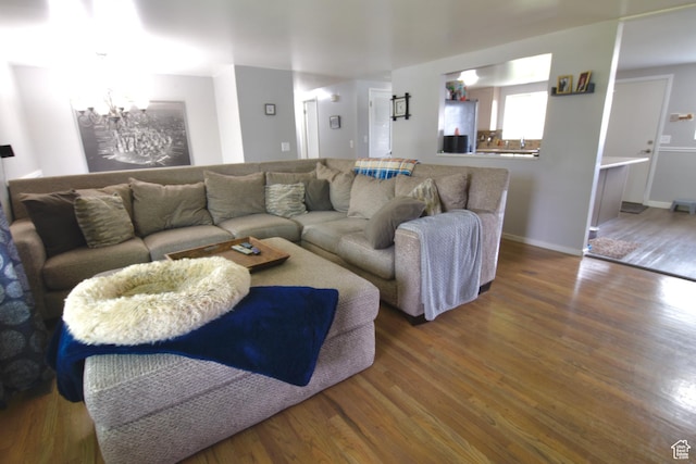 3223 S Fairlane St, Magna, UT 84044 - living room with baseboards, wood finished floors, and a notable chandelier