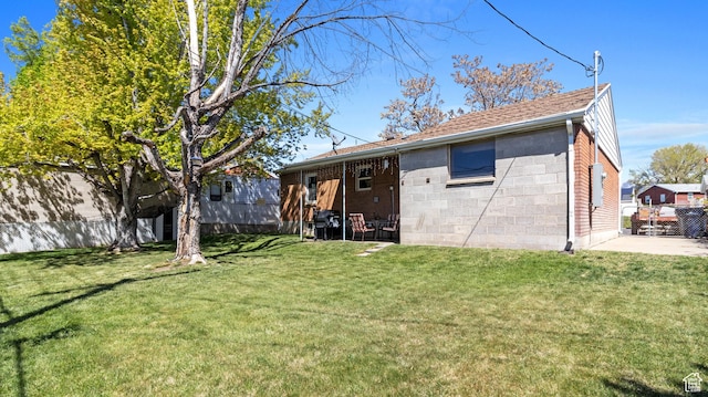 278 S 750 E, Clearfield, UT 84015 - rear view of house with a patio, fence, a lawn, and concrete block siding