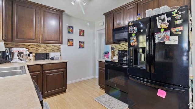 278 S 750 E, Clearfield, UT 84015 - kitchen with light wood finished floors, baseboards, black appliances, light countertops, and decorative backsplash