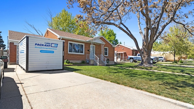 278 S 750 E, Clearfield, UT 84015 - view of front of home featuring a shingled roof, brick siding, and a front lawn