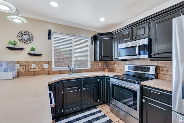 2363 W 960 N, Provo, UT 84601 - kitchen featuring backsplash, dark cabinets, appliances with stainless steel finishes, and a sink
