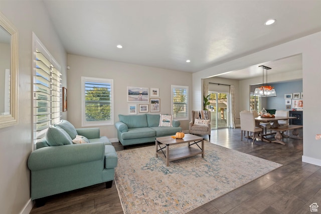 15176 S Battle Dr, Bluffdale, UT 84065 - living room with plenty of natural light, recessed lighting, dark wood finished floors, and baseboards