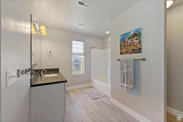15176 S Battle Dr, Bluffdale, UT 84065 - bathroom with baseboards, vanity,  shower combination, and visible vents