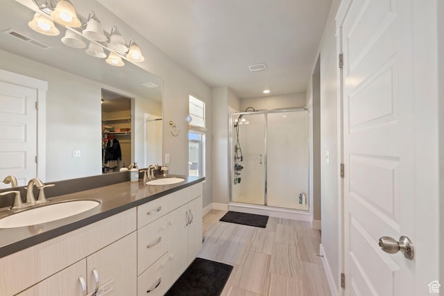 15176 S Battle Dr, Bluffdale, UT 84065 - bathroom with a sink, a walk in closet, a shower stall, and visible vents