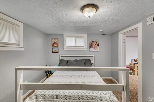 133 E 7th St S, Ogden, UT 84404 - carpeted bedroom featuring baseboards and a textured ceiling