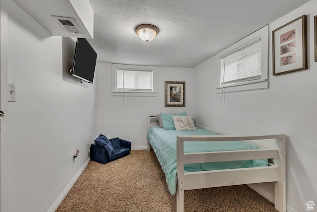 133 E 7th St S, Ogden, UT 84404 - carpeted bedroom with a textured ceiling, visible vents, and baseboards