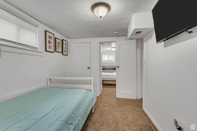 133 E 7th St S, Ogden, UT 84404 - bedroom with visible vents, a textured ceiling, baseboards, and light colored carpet