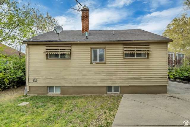 133 E 7th St S, Ogden, UT 84404 - view of side of property with a lawn, roof with shingles, a chimney, and a patio