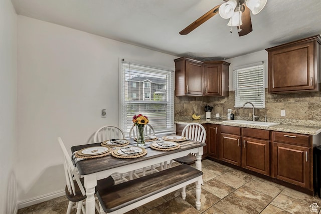133 E 7th St S, Ogden, UT 84404 - kitchen featuring dark brown cabinetry, a ceiling fan, stone finish flooring, tasteful backsplash, and a sink