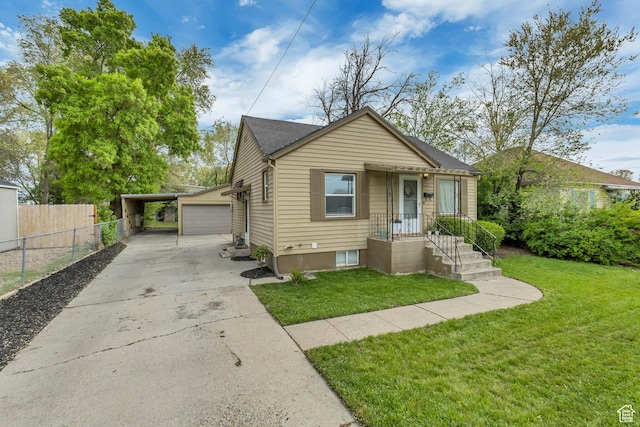 133 E 7th St S, Ogden, UT 84404 - bungalow-style home with a front lawn, fence, driveway, and a carport