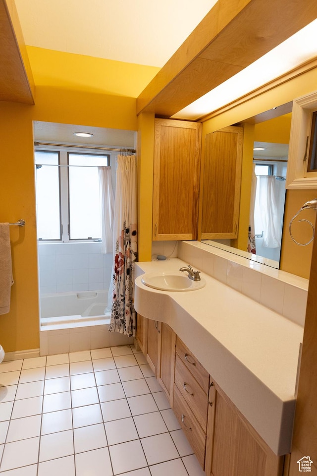 970 E Wilson Ave S, Salt Lake City, UT 84105 - full bathroom featuring healthy amount of natural light, tile patterned floors, vanity, and shower / tub combo