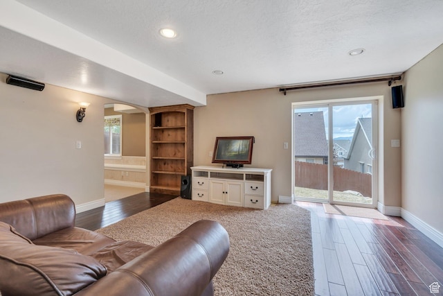 2797 W Fox Hunters Loop, Lehi, UT 84043 - living room with recessed lighting, baseboards, arched walkways, and dark wood-type flooring