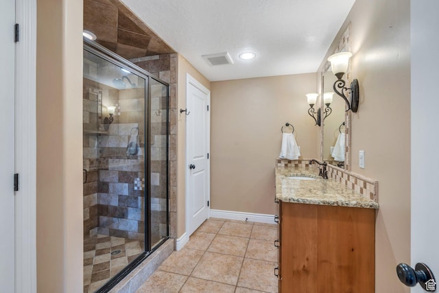 2797 W Fox Hunters Loop, Lehi, UT 84043 - bathroom featuring vanity, tile patterned floors, baseboards, a shower stall, and visible vents