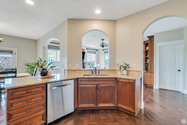 2797 W Fox Hunters Loop, Lehi, UT 84043 - kitchen featuring a sink, arched walkways, dark wood finished floors, plenty of natural light, and stainless steel dishwasher