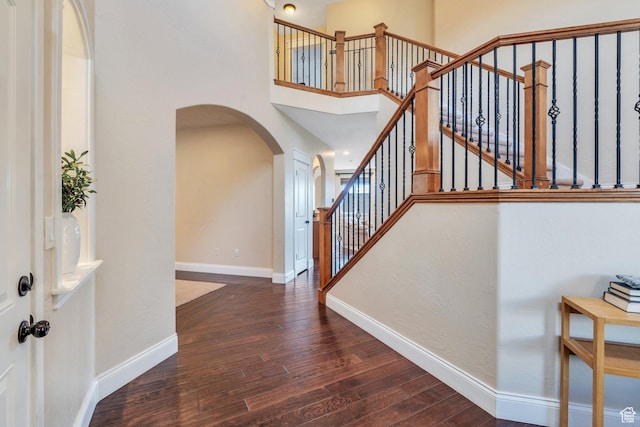 2797 W Fox Hunters Loop, Lehi, UT 84043 - foyer featuring a towering ceiling, arched walkways, wood finished floors, baseboards, and stairs