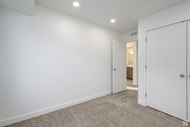 246 E Wasatch Ave Unit 201, Midvale, UT 84070 - unfurnished bedroom with light colored carpet, baseboards, recessed lighting, and a closet