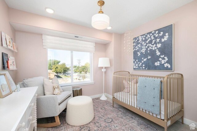 246 E Wasatch Ave Unit 201, Midvale, UT 84070 - bedroom with baseboards and a crib
