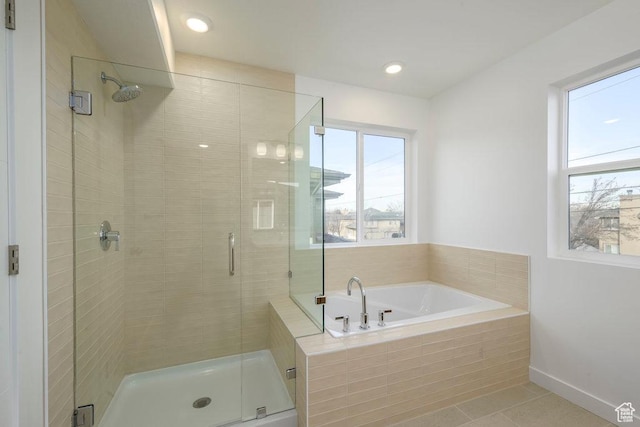 246 E Wasatch Ave Unit 201, Midvale, UT 84070 - full bath featuring healthy amount of natural light, a stall shower, tile patterned floors, a garden tub, and recessed lighting