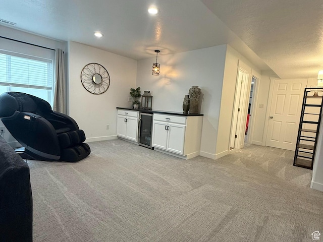 1196 W Zenith Cir, Saratoga Springs, UT 84045 - living room with visible vents, baseboards, beverage cooler, light colored carpet, and a bar