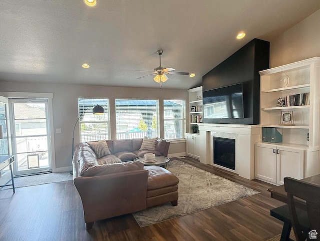 1196 W Zenith Cir, Saratoga Springs, UT 84045 - living area featuring a fireplace, a ceiling fan, baseboards, vaulted ceiling, and dark wood-style floors