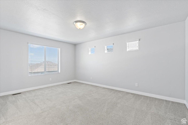 4264 W Abbey Bend Ln, Herriman, UT 84096 - spare room featuring healthy amount of natural light, carpet, baseboards, and a textured ceiling