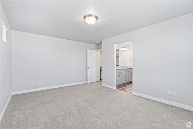 4264 W Abbey Bend Ln, Herriman, UT 84096 - unfurnished bedroom with light colored carpet, baseboards, and ensuite bath