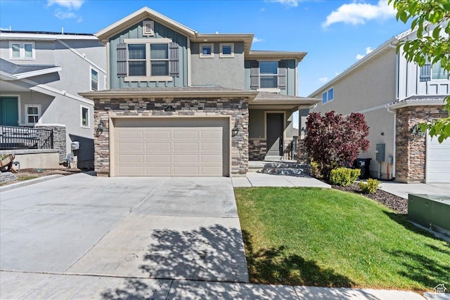 view of front of home with a garage, a front lawn, stone siding, board and batten siding, and concrete driveway