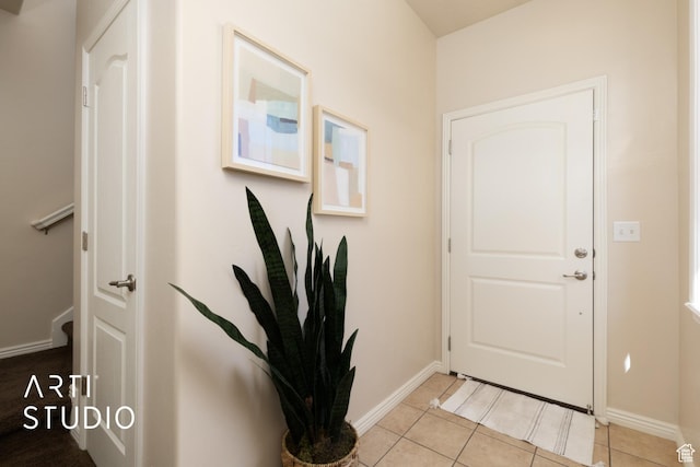 entryway featuring baseboards and light tile patterned flooring