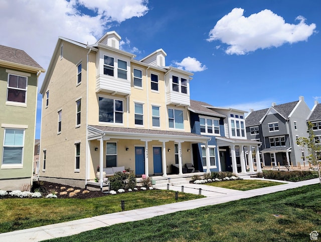 6688 W 11800 S, South Jordan, UT 84009 - townhome / multi-family property featuring a front lawn, stucco siding, and covered porch