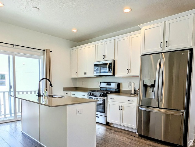 6688 W 11800 S, South Jordan, UT 84009 - kitchen with dark wood-style flooring, a kitchen island with sink, white cabinetry, a sink, and stainless steel appliances