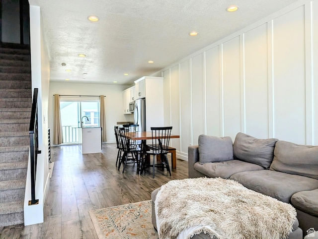 6688 W 11800 S, South Jordan, UT 84009 - living room with stairs, recessed lighting, a textured ceiling, and wood finished floors
