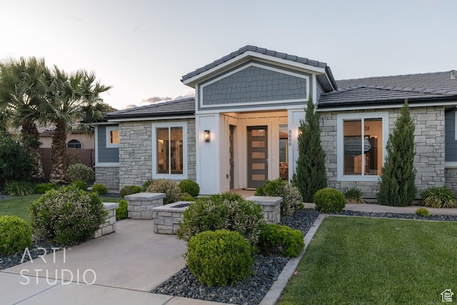 view of front of property with stone siding and a front yard