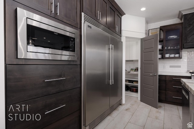 3658 W 2510 S, Hurricane, UT 84737 - kitchen featuring dark brown cabinetry, built in appliances, tasteful backsplash, and light countertops