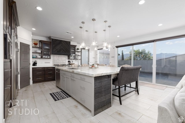3658 W 2510 S, Hurricane, UT 84737 - kitchen featuring a breakfast bar area, recessed lighting, a sink, premium range hood, and backsplash
