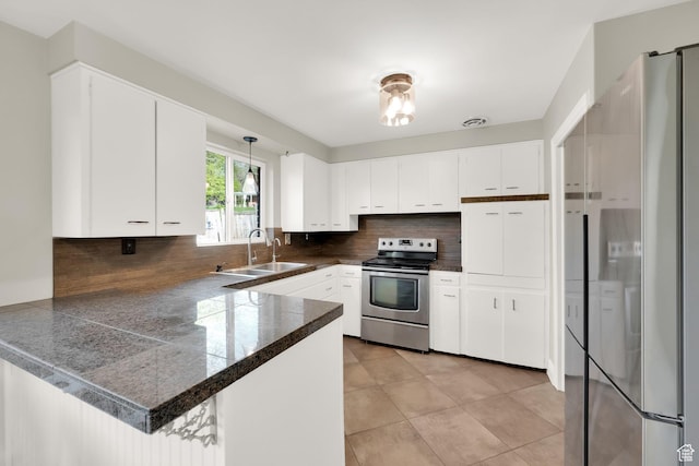 257 E Kingdon S, North Salt Lake, UT 84054 - kitchen featuring white cabinets, a sink, tile counters, stainless steel appliances, and tasteful backsplash