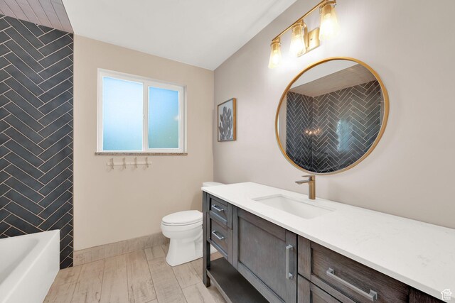 257 E Kingdon S, North Salt Lake, UT 84054 - full bathroom with vanity, baseboards, a bathtub, and toilet