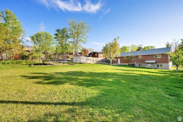 257 E Kingdon S, North Salt Lake, UT 84054 - view of yard featuring a trampoline and fence