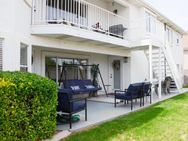 1087 E Fort Pierce Dr, St George, UT 84790 - rear view of house with a balcony, stucco siding, an outdoor living space, a patio area, and stairway
