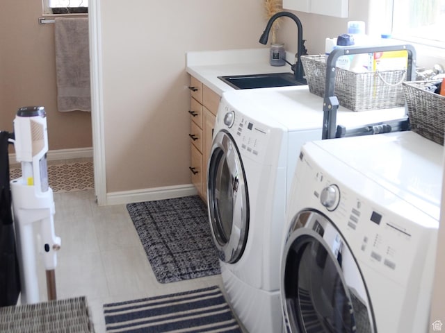 1087 E Fort Pierce Dr, St George, UT 84790 - laundry area with washing machine and clothes dryer, baseboards, a sink, and cabinet space