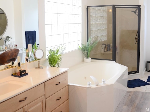 1087 E Fort Pierce Dr, St George, UT 84790 - bathroom with vanity, wood finished floors, a garden tub, and a stall shower