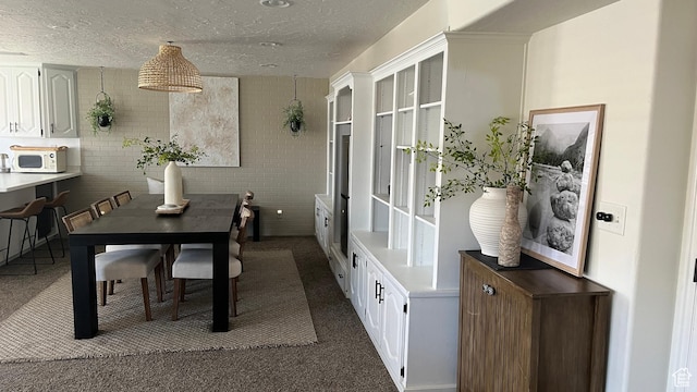 1087 E Fort Pierce Dr, St George, UT 84790 - dining area with dark colored carpet and a textured ceiling