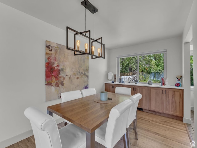 4363 S Butternut Rd E, Holladay, UT 84124 - dining space featuring baseboards, a chandelier, and light wood finished floors