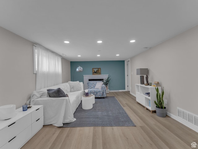 4363 S Butternut Rd E, Holladay, UT 84124 - living area with a brick fireplace, light wood-style flooring, recessed lighting, baseboards, and visible vents
