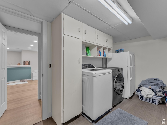 4363 S Butternut Rd E, Holladay, UT 84124 - laundry area with light wood-style flooring, recessed lighting, cabinet space, and washer and clothes dryer
